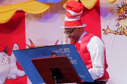 man reading cat in the hat at seuss-a-palooza story time onboard carnival dream