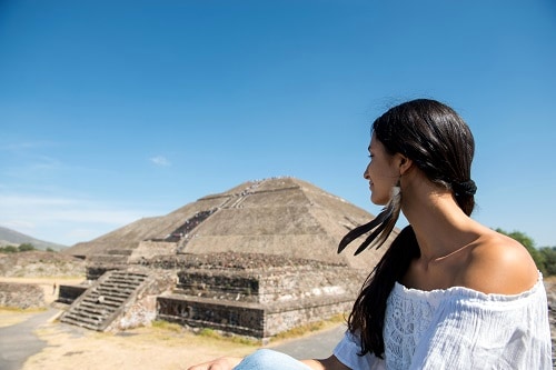 woman staring at a mayan pyramid found in the western caribbean