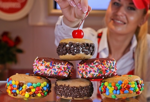 woman adding a cherry on top of ice cream sandwiches from swirls onboard carnival dream