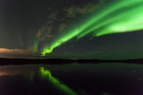 northern lights over the water in alaska