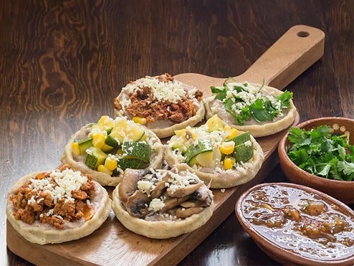 a tray of meat and veggie sopes