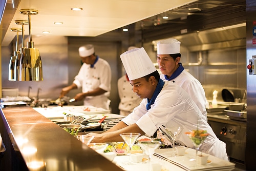 chefs preparing meals onboard carnival’s steakhouse