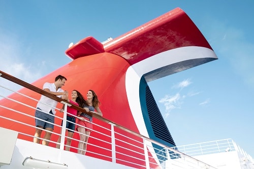 family standing by the funnel of a carnival ship
