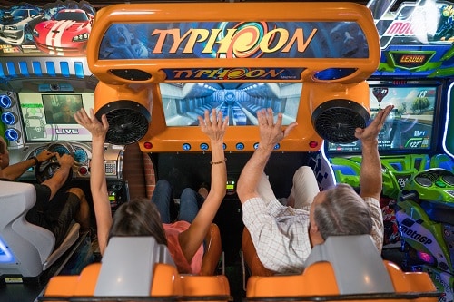 two people enjoying a game from the video arcade