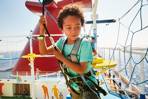 a child making their way through the ropes course