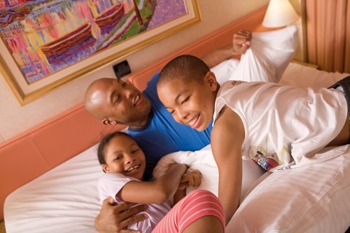 a father tucking his children into bed after an exciting day of cruising