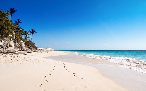 a trail of footprints on elbow beach in bermuda