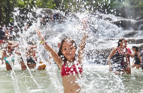 little girl splashing at dunns river falls