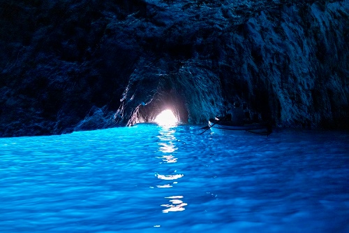 two people paddling in the blue grotto