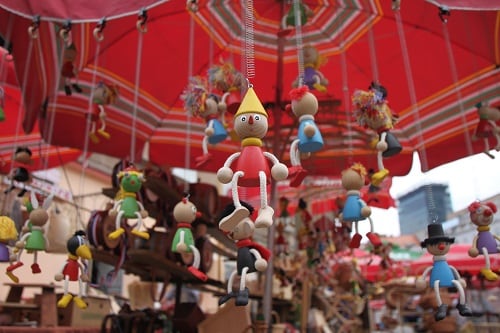 wooden toys hanging off a marketplace in croatia