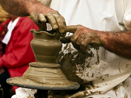 a maltese pottery artist sculpts a small vase