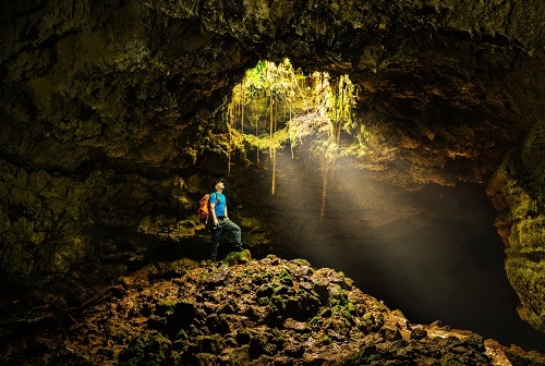 backpacker in a volcanic cave in the azores