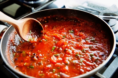 tomato sauce being heated up on a stove