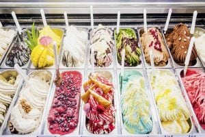 a variety of gelato on display at an italian market