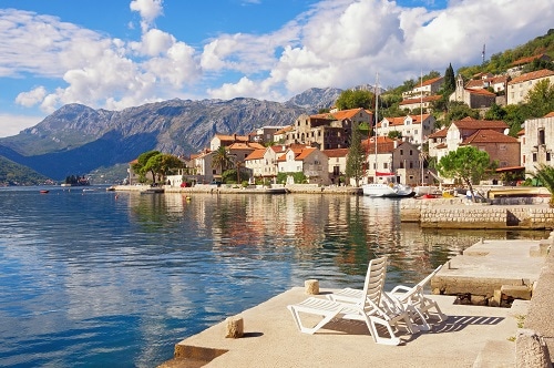 a wide view of kotor bay and the mountains on a sunny day
