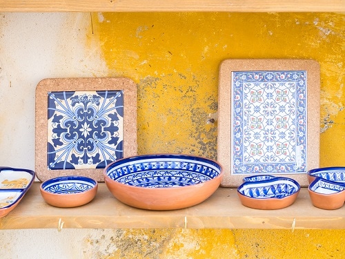 azulejo tiles on display with ceramic pottery