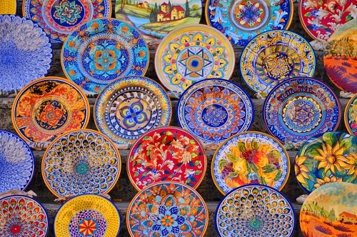 ceramic plates for sale at a market in livrono, italy