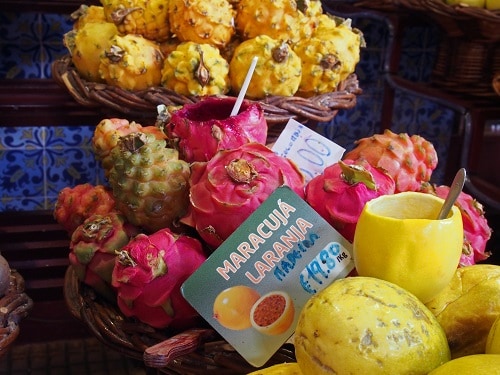 dragon fruit and passionfruit for sale at a portuguese marketplace in funchal