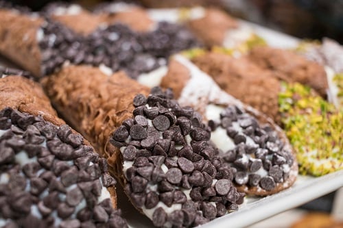 a tray of cannoli in a sicilian bakery
