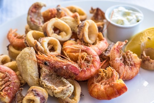 fried shrimp and calamari on a white plate