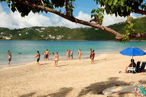 group of people gathered around a beach in the caribbean