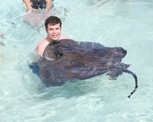young man holding a stingray in grand turk