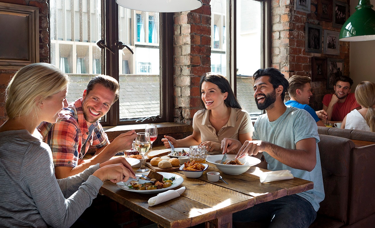 Group of friends enjoying a meal in a restaurant.