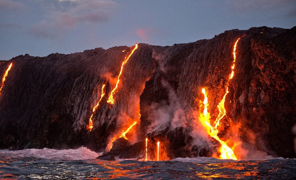 Hawaiian volcano with lava running into the ocean