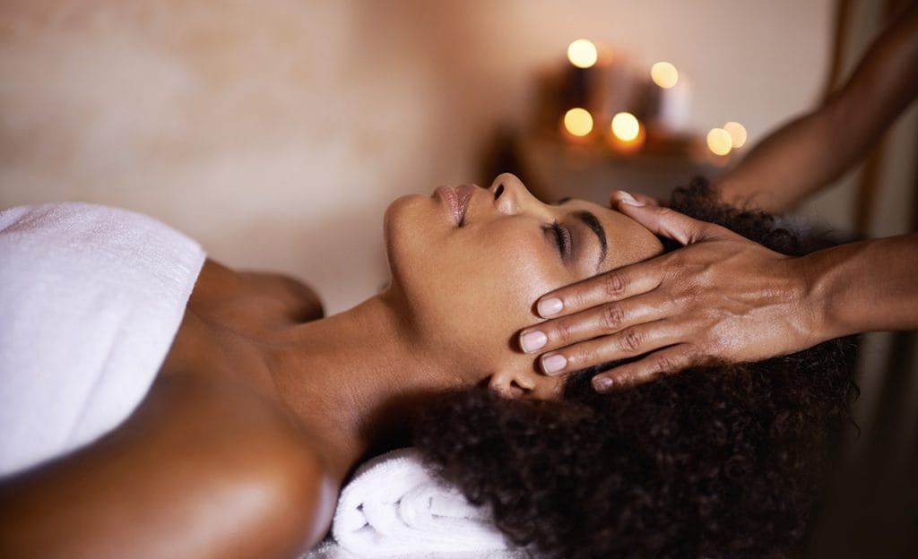 African American woman getting a massage at a spa