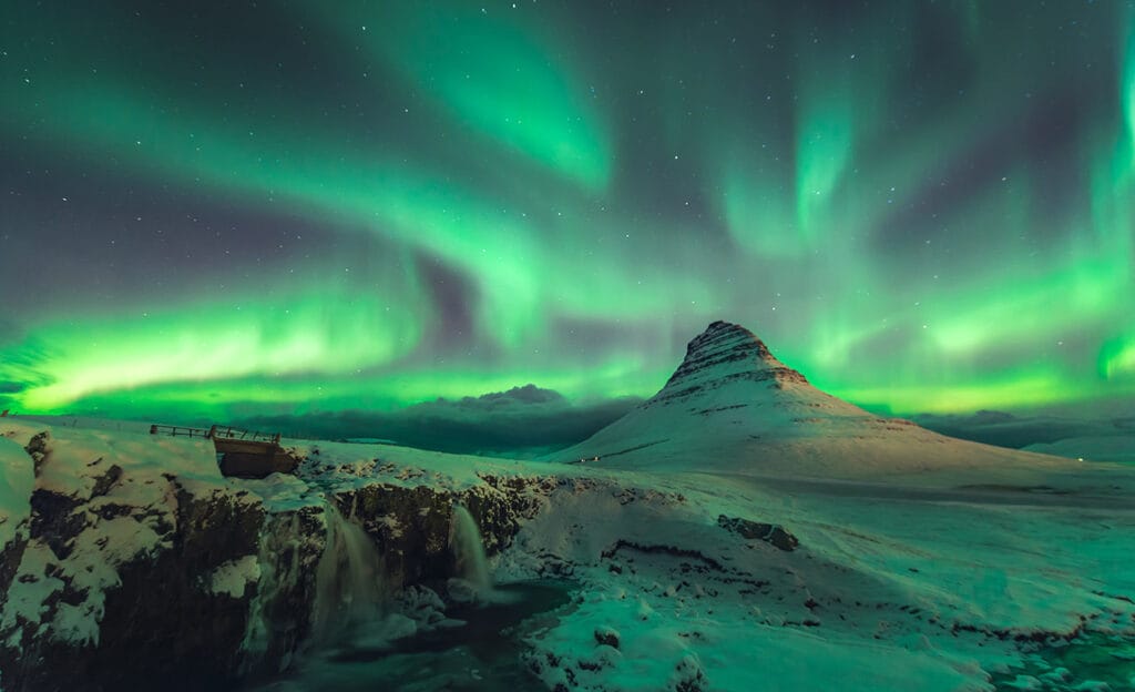 Northern Lights over a snowy landscape.