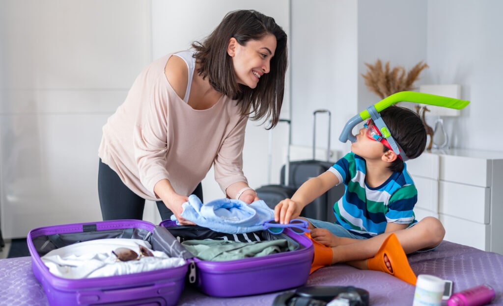 Mother and son packing for vacation