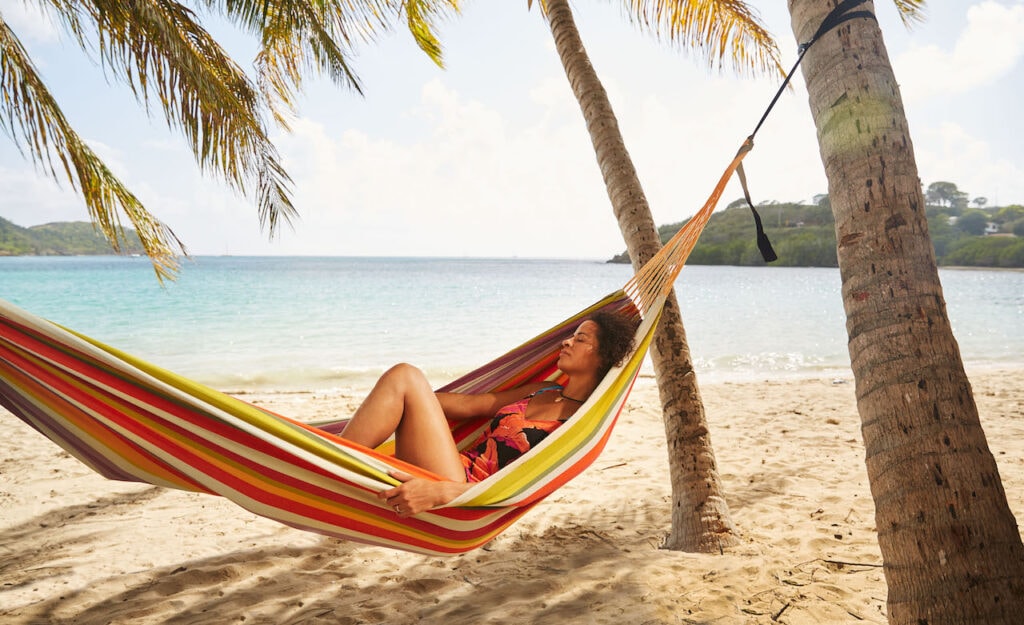 Woman relaxing on a beach hammock