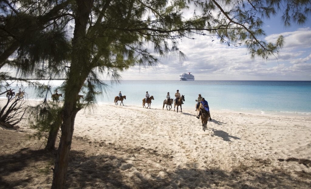 Group horseback riding on Half Moon Cay's beaches