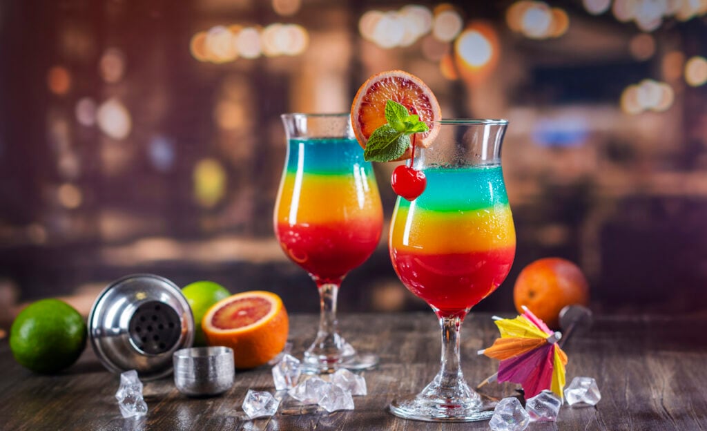 Close-up shot of two summer rainbow layered cocktails.