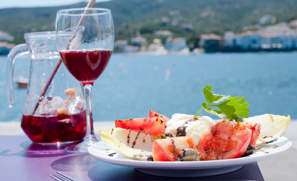 A glass of sangria and mozzarella salad along Costa Brava, Spain.
