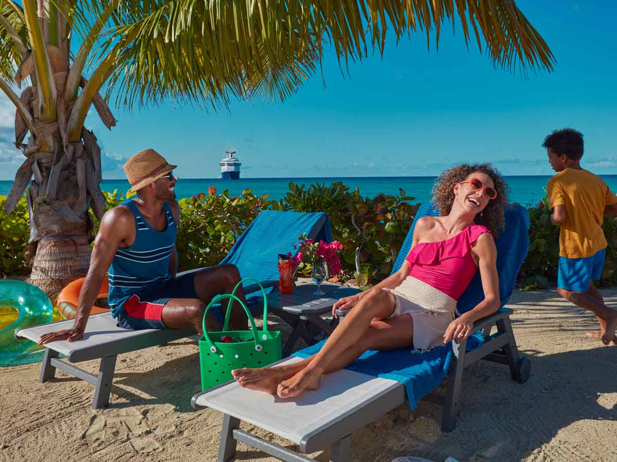 family relaxing on beach