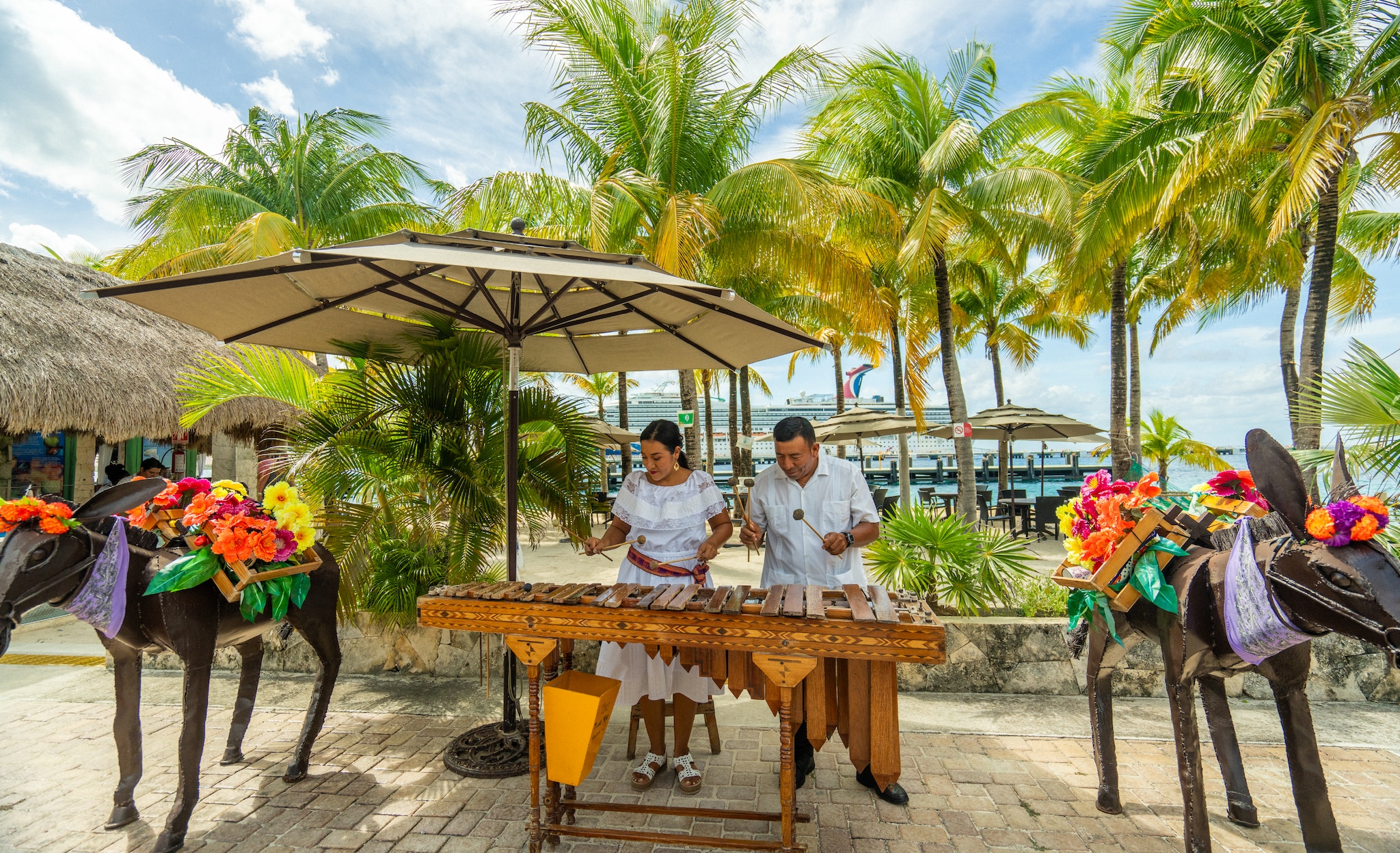 Woman and man playing marimba in Cozumel (wide shot)]