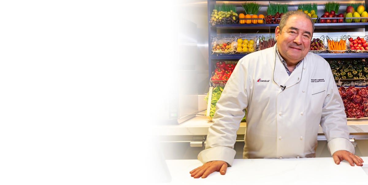 emeril lagasse smiles in a kitchen