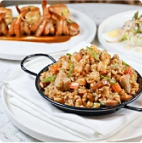 rice and chicken is served on a black dish